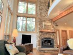 Settle into the great room with a majestic stone fireplace, wooded views and TV to stream on your own app or watch watch